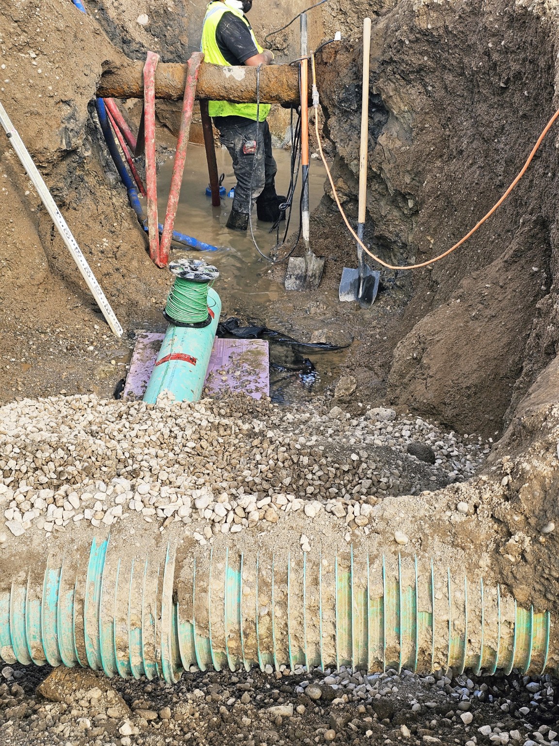 Storm and sanitary utility services exposed within an active excavation